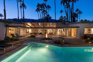 A modern house with a swimming pool, outdoor seating, and a fire pit. - Deepwell Mid-Century Classic (Palm Springs)