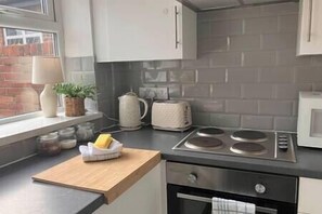 Enjoy cooking in this well-equipped kitchen with an oven, countertop, and toaster.