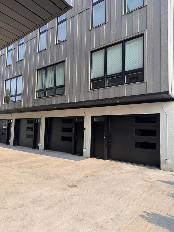 A modern building with multiple garage doors and large windows.