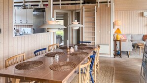 A wooden interior with a dining table, chairs, and a kitchen area. - Awesome home in Sydals with kitchen (Sydals)