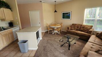 A compact living space with a kitchen, dining area, and seating area.