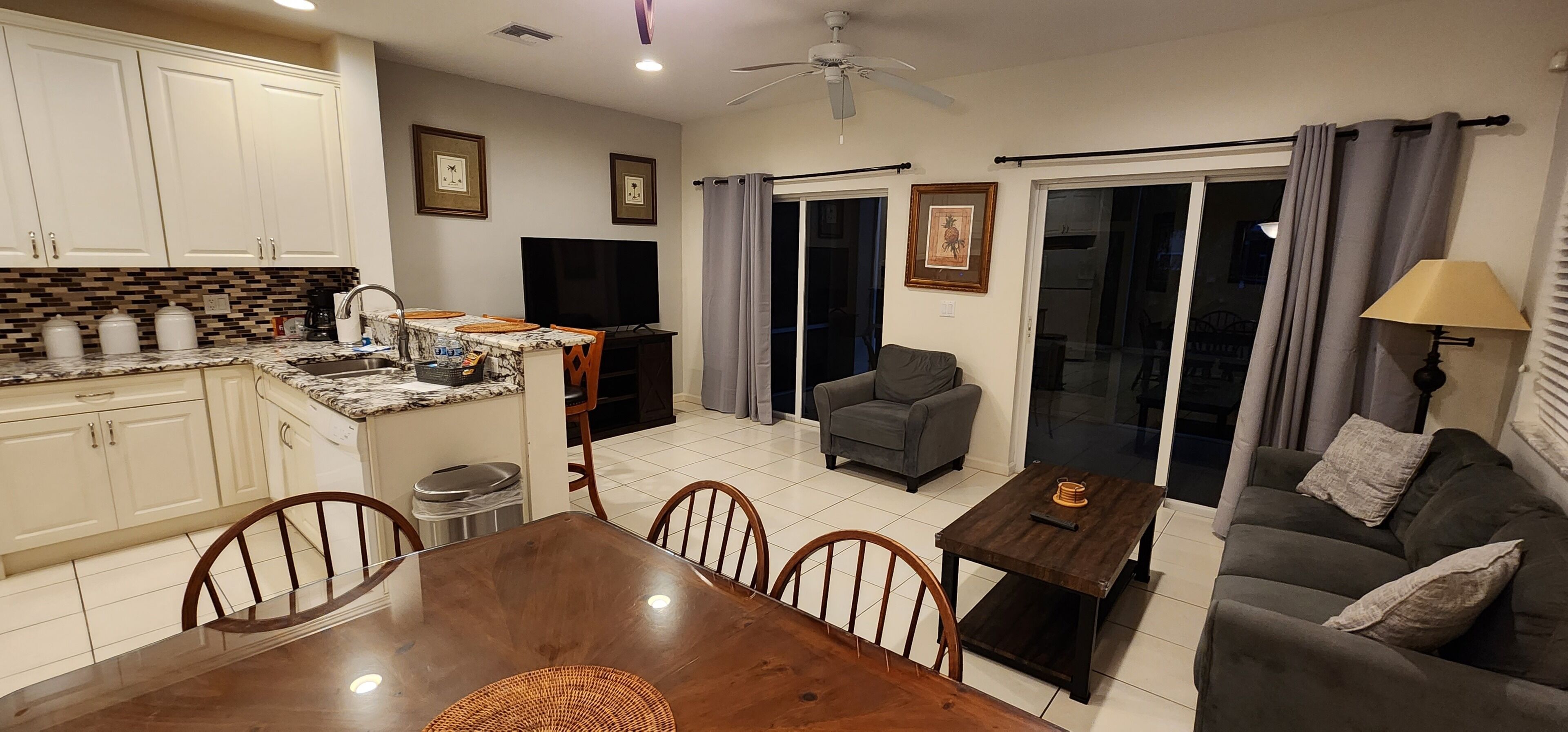 A compact living space with a kitchen, dining area, and a sofa.