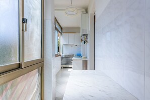 A modern kitchen with white cabinets, a stainless steel oven, and a marble countertop. - GuestHost - Cozy and roomy apartment 93 sqm located on the first floor of a building WITHOUT a lift (stairs to access) can accommodate up to 6 people. The property, equipped with all the main comforts: bars, restaurants, supermarkets and pharmacy.The acc (Viareggio)