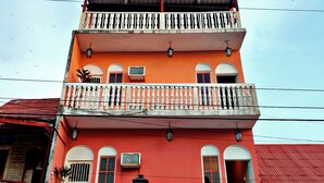 A multi-story building with balconies, a sign indicating it is a hotel, and a visible entrance. - Hotel Posada de la Jungla (Flores)