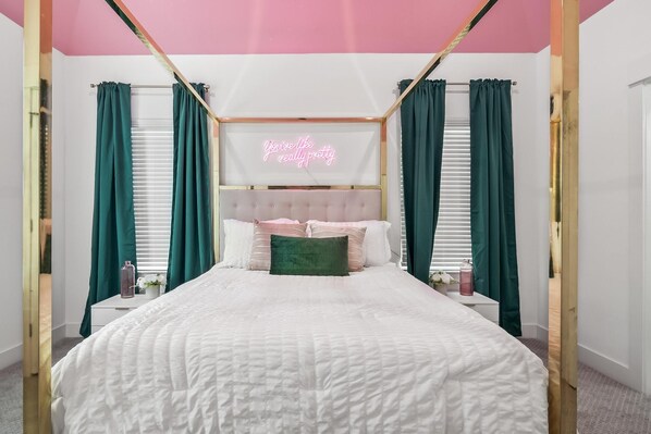 A bedroom with a four-poster bed, green curtains, a neon sign, and a white headboard. - Stylish Multi-level home, minutes to Downtown (Houston)