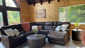 Un salon chaleureux avec un canapé d’angle, une table basse et une plante en pot.