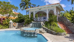 A swimming pool with a waterfall feature, a gazebo, and a stone staircase. - The Anchorage #5 a 3 bedroom Waterfront Condo in Rodney Bay (Rodney Bay)