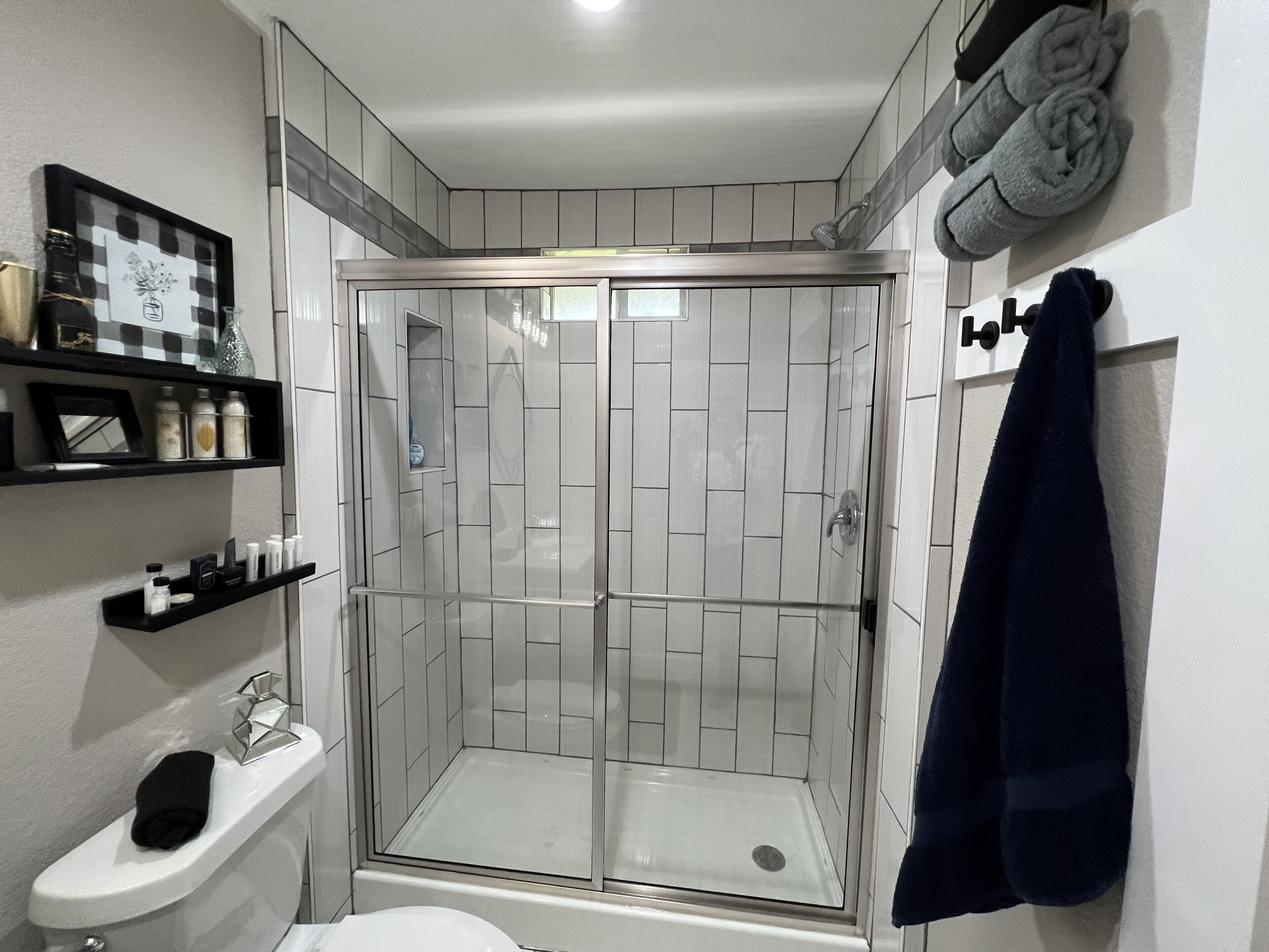 Shower, hair dryer, towels, toilet paper