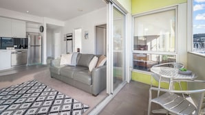 A modern apartment with a living room, kitchen, and balcony. - Bellerive Quay - 2 Bedroom Apartment (Bellerive)