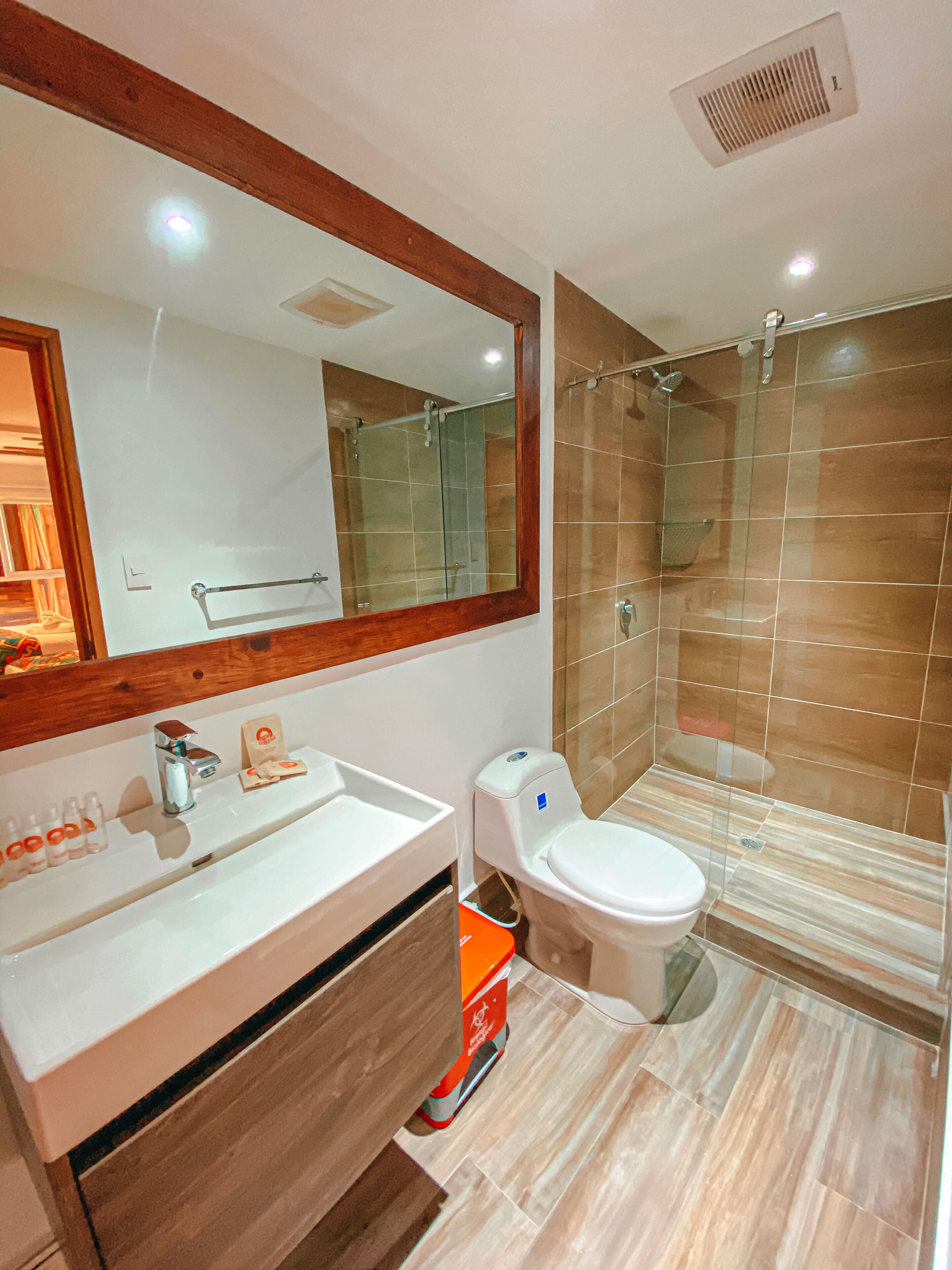 deluxe quadruple room | bathroom | shower, soap, toilet paper