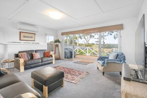 Deluxe House | Living area | 60-inch Smart TV with digital channels, TV, DVD player