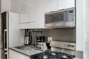 Fridge, microwave, oven, stovetop - Premium West Village 1BR w/ High Ceilings, Skylight & W/D, by Blueground (Downtown)