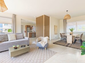Relax in this inviting living space with a comfortable sofa, dining area, and kitchenette.