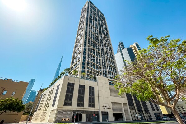 A modern building with a prominent vertical design, large windows, and a flat roof.