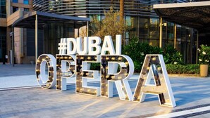 A sign with the words #DUBAI OPERA in large, illuminated letters.