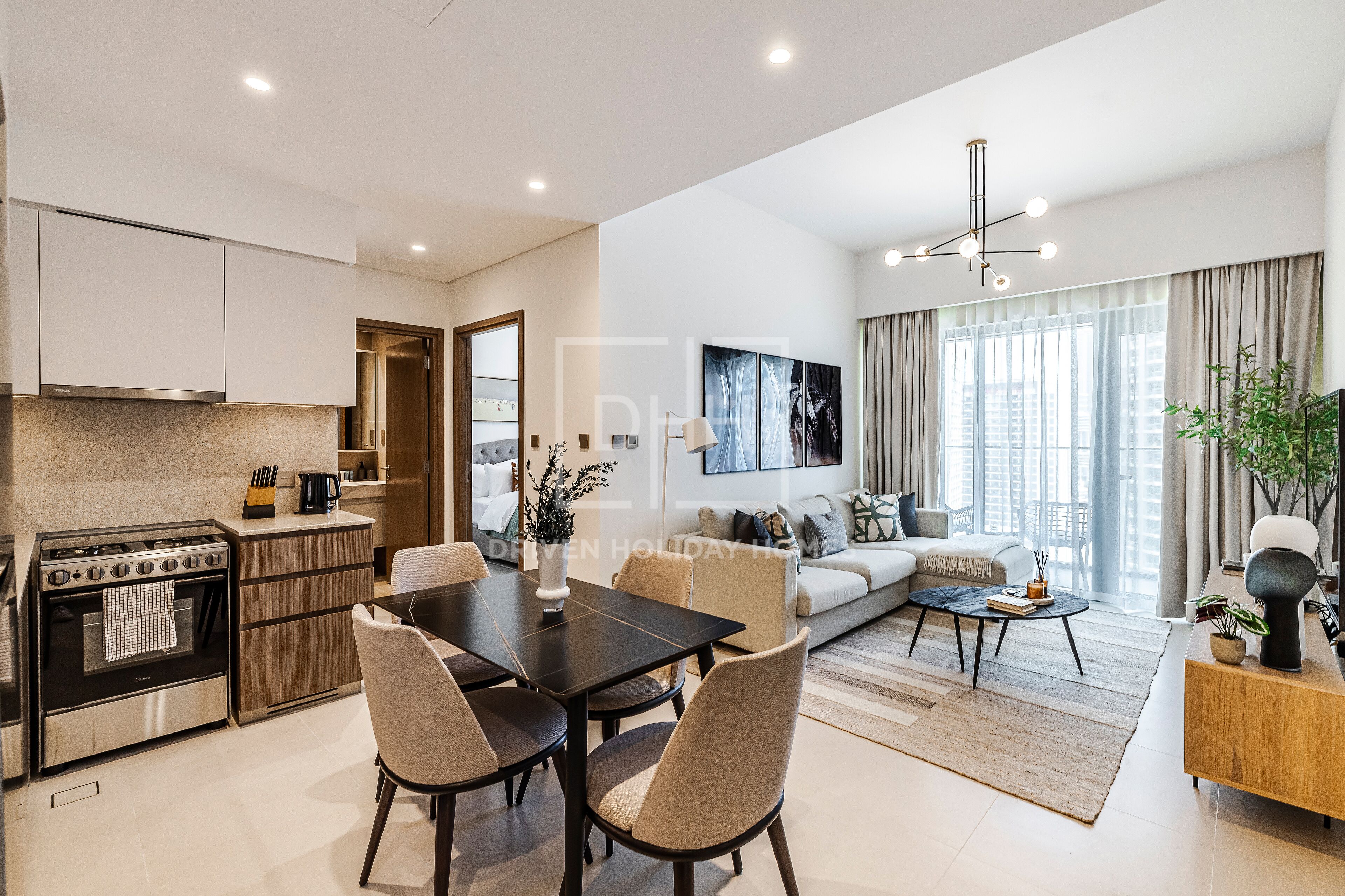 A modern apartment with a kitchen, dining area, and living room.