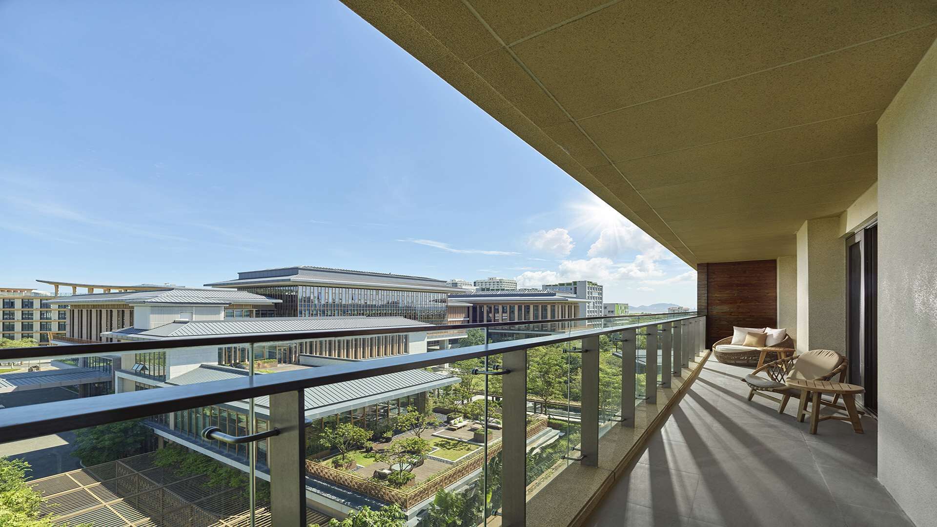 A balcony with a clear view of surrounding buildings and greenery.