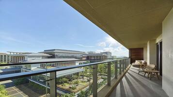 A balcony with a clear view of surrounding buildings and greenery.
