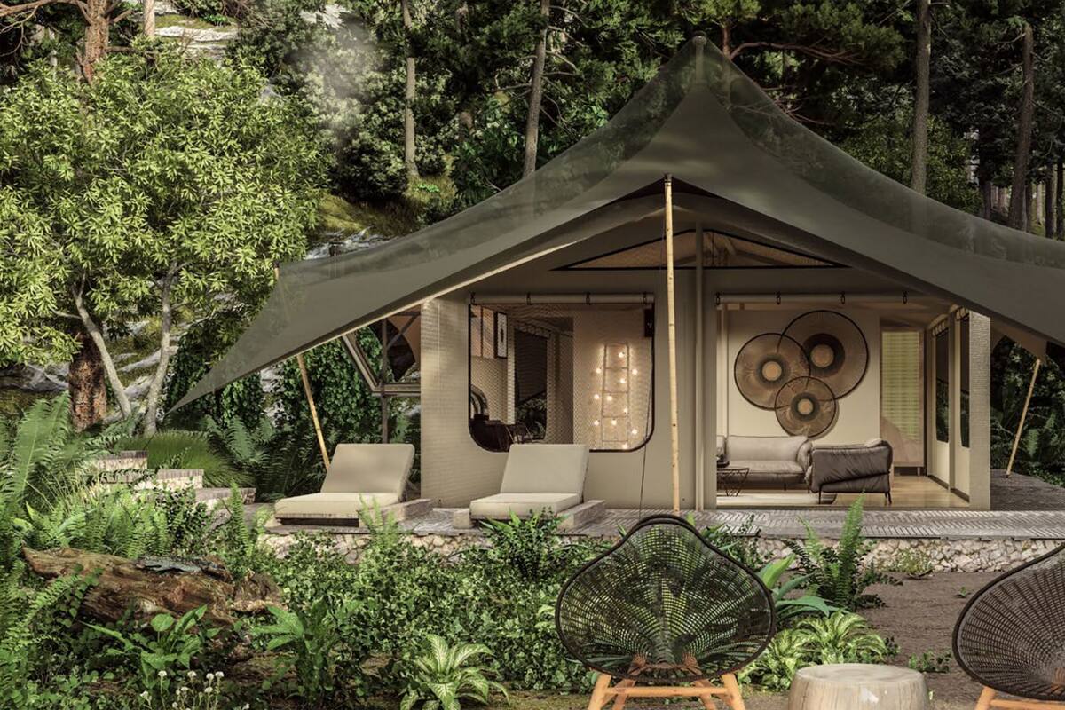 A modern, enclosed outdoor living space with a canopy, furnished with seating and a fireplace, surrounded by lush greenery.