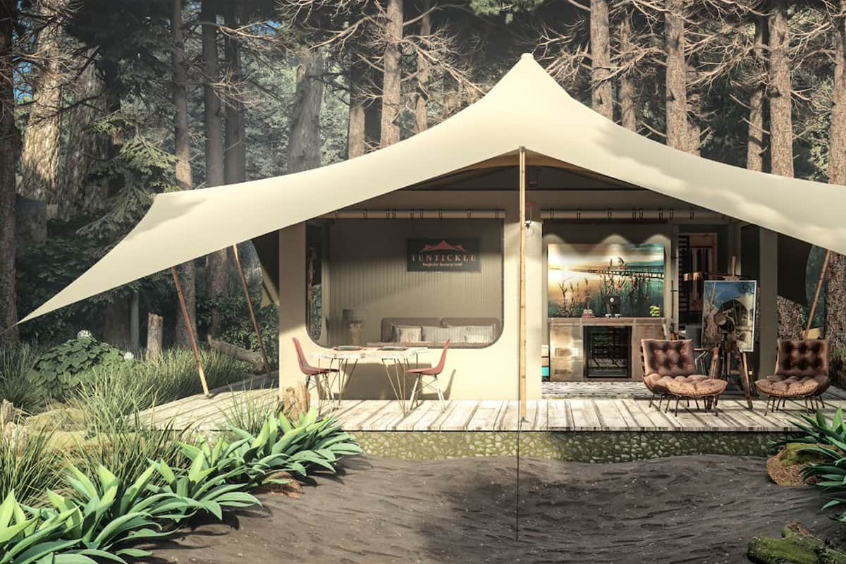 A tented structure with a dining area, a bar, and a seating area with cushioned chairs.