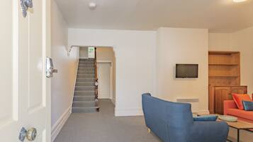 Standard House | Living area | 70-inch TV with digital channels