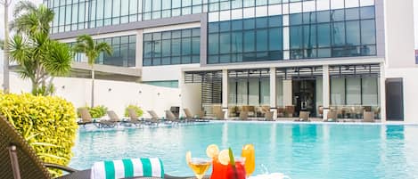 Outdoor pool, open 7:00 AM to 7:00 PM, pool loungers, lifeguards on site