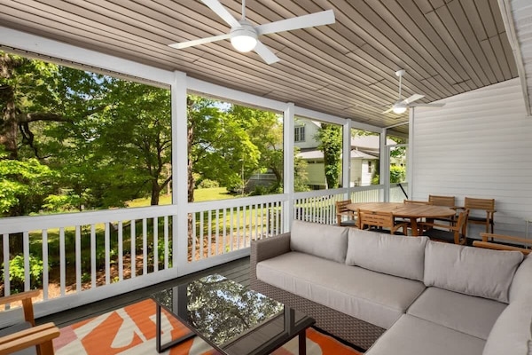 Embrace the serenity of trees and fresh air while relaxing on this porch.