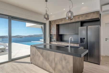 Villa | Private kitchen | Full-size fridge, microwave, oven, dishwasher