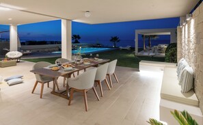 Outdoor dining - Unique beachfront location, heated pool with built-in hydromassage, large garden (Heraklion)