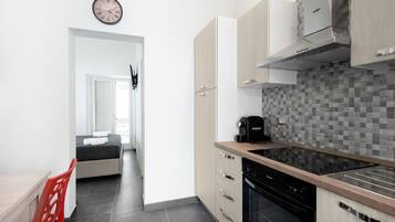 Fridge, electric kettle, coffee grinder, cookware/dishes/utensils