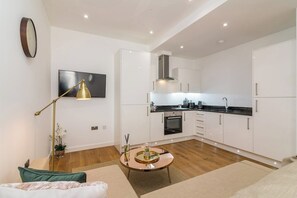 A modern apartment with a living room, a dining area, and a kitchen. - Lovely 1 Bedroom Apartment at City Centre (Nottingham)