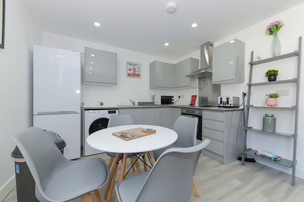 Enjoy cooking in this well-equipped kitchen with a refrigerator, oven, and microwave. Dine at the table with four chairs.