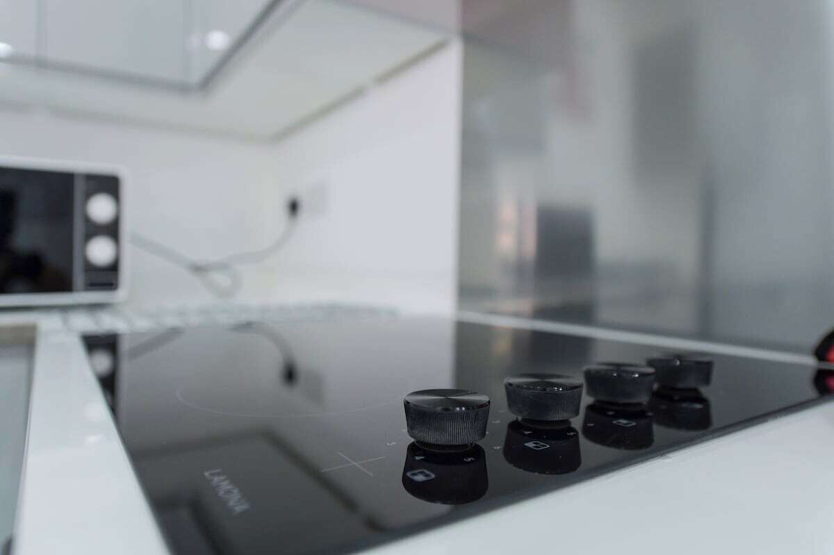 Cuina amb una placa d'inducció moderna i un microones.