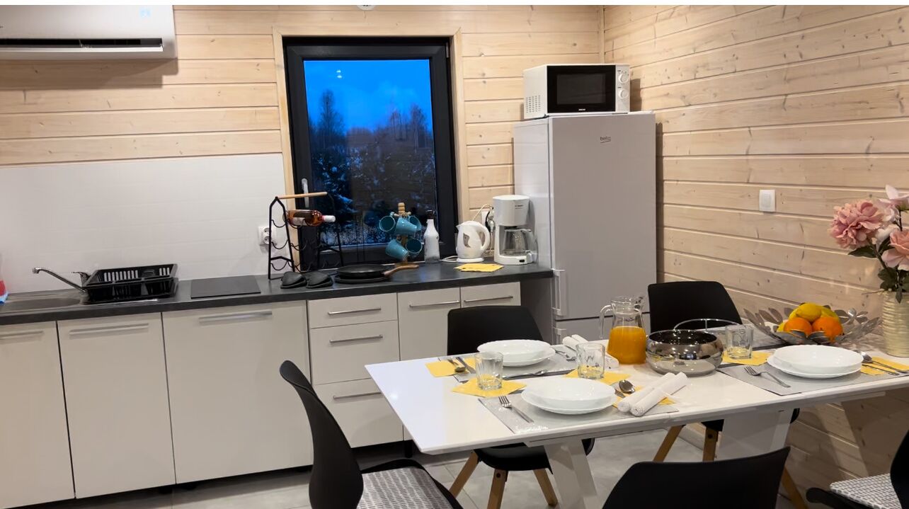 Una cucina compatta con zona pranzo, dotata di forno a microonde, macchina del caffè e un'ampia finestra con vista panoramica.