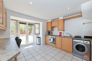 Enjoy cooking in this well-lit kitchen with a dishwasher, oven, and sink.