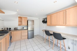 Enjoy cooking in this fully equipped kitchen with a refrigerator, microwave, toaster, sink, and coffee maker.