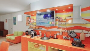 A compact kitchen with a central island, a built-in oven, and a microwave. - Family apartment: sleeps 6, Use of garden, sunbeds and swimming pool. (Monte San Pietro)