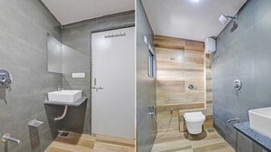 A modern bathroom with a shower, toilet, and sink. - Hotel Neelkamal (Ahmedabad)
