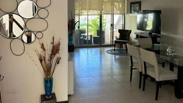 Un salon moderne comprenant un coin repas, un téléviseur et un ventilateur de plafond.
