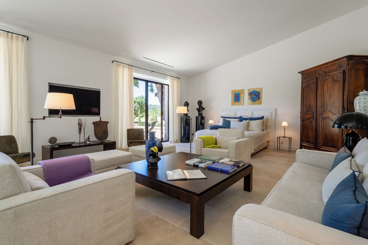 A modern living room with a sofa, coffee table, and a TV.