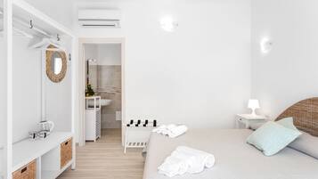 A modern bedroom with a bed, bedside table, and a wardrobe.