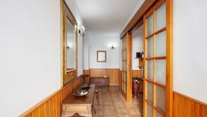 A narrow hallway with wooden paneling, a bench, and a table with a plate and a cup. - Holiday Home 'Casa Ariadna' with Sea Views, Private Garden, and Wi-Fi (Tijarafe)