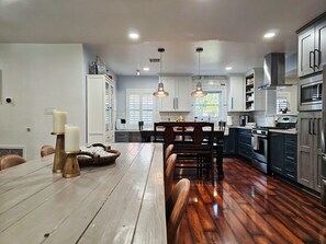 Enjoy cooking in this well-equipped kitchen with a central island, ample counter space, and modern appliances.