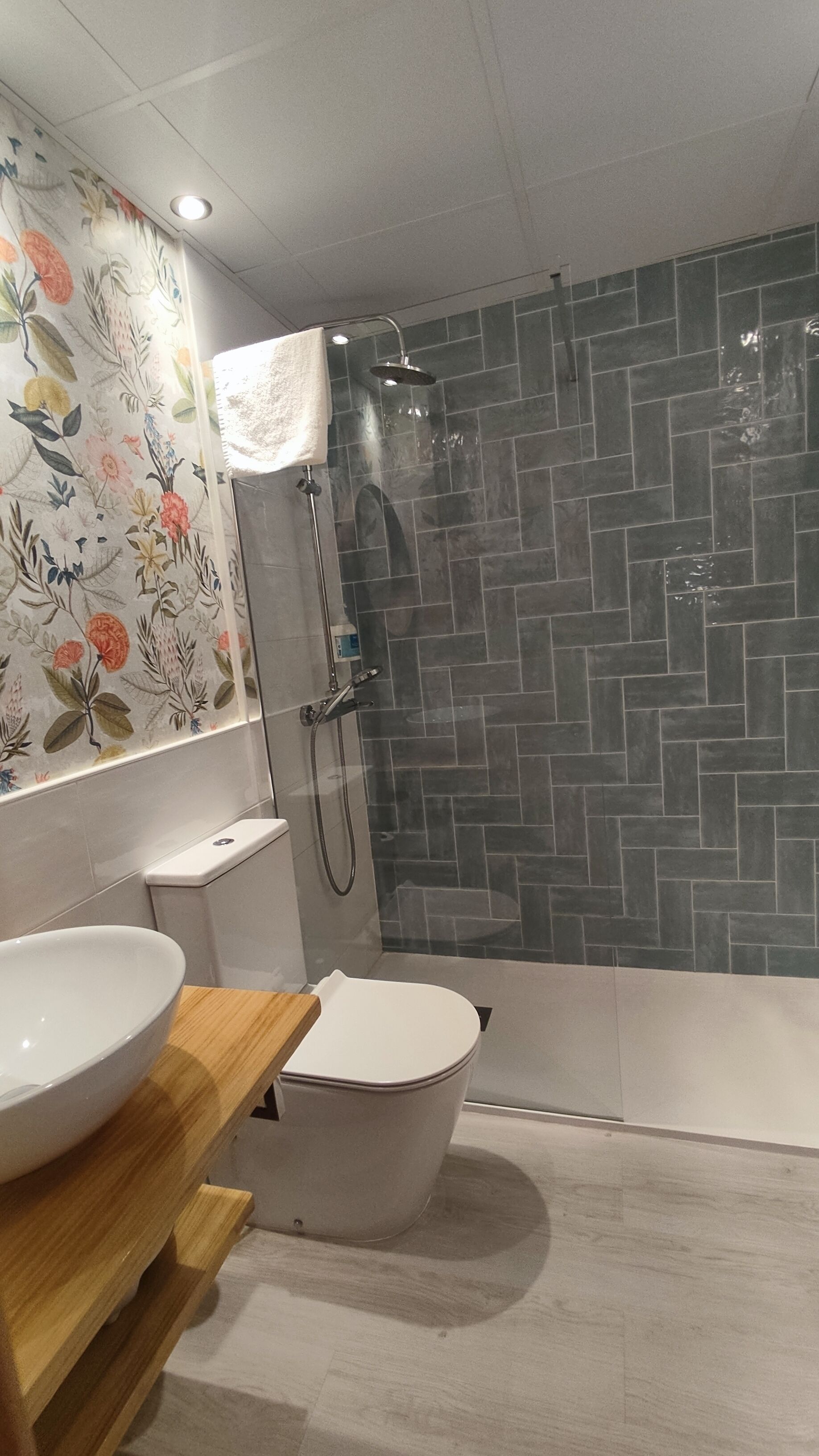 A modern bathroom with a freestanding bathtub, a toilet, and a sink.