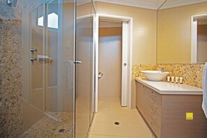 Bathtub, hair dryer, towels, toilet paper