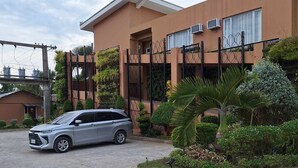 A modern building with a car parked in front.