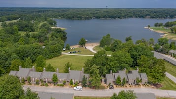 A residential area with houses, a lake, and a golf course.
