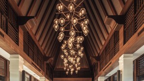 A spacious lobby with a large seating area, a chandelier, and wooden paneling. - Dusit Thani Himalayan Resort Dhulikhel Nepal (Dhulikhel)