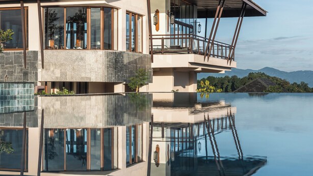 A modern building with a large balcony, a pool, and a clear view of the surrounding landscape. - Dusit Thani Himalayan Resort Dhulikhel Nepal (Dhulikhel)