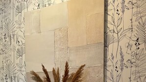 A wooden console table with three potted plants and a wall-mounted artwork. - Stylish duplex on an award-winning vineyard; shared pool; close to the Cevennes (Brissac)